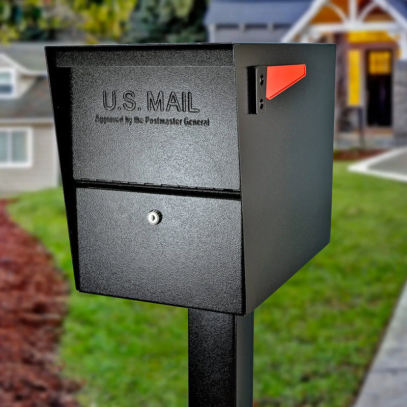 Black locking package mailbox on a post in front of a house